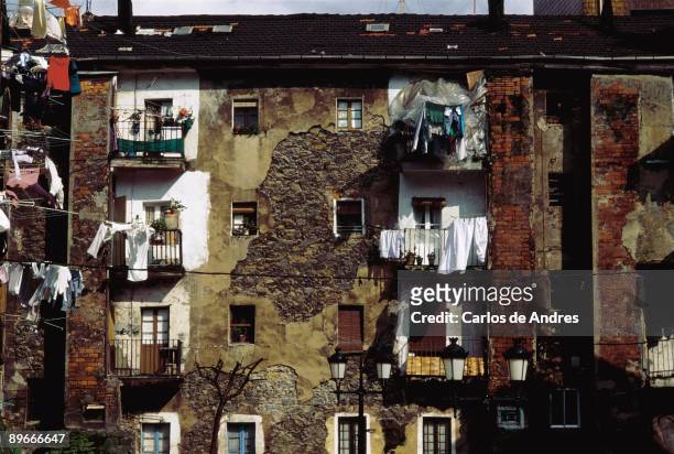 Facades of old buildings of Sestao Detail of the balconies with hung clothes in the facade of an old and deteriorated building of Sestao. Biscay...