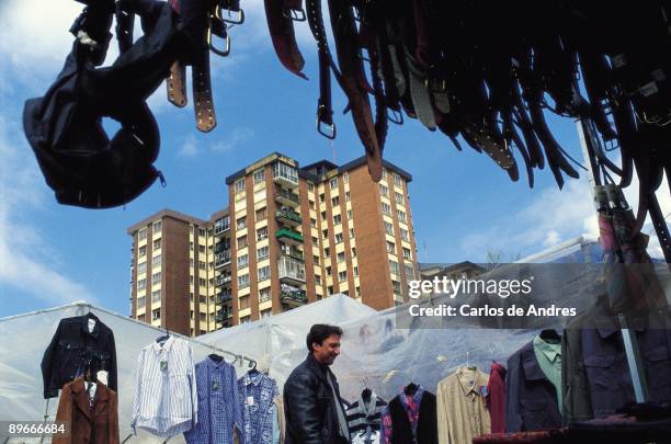 Stand in a marlket in Bilbao Traveling salesman in a stand of clothes in a market of Bilbao