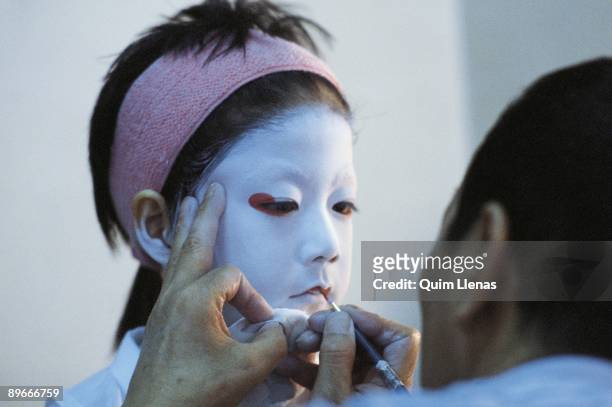 Kabuki actor in a make up session Actor of the company of Ichikawa Ennosuke during his making up