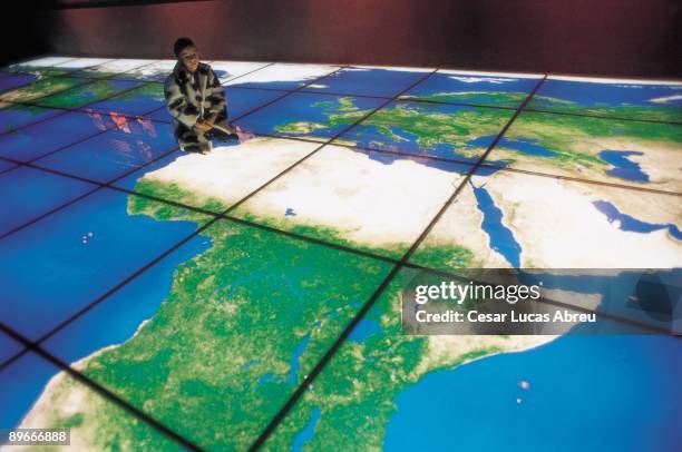 Biological park of Valdebernardo, Madrid A young girl are over an huge biological world map in the ground