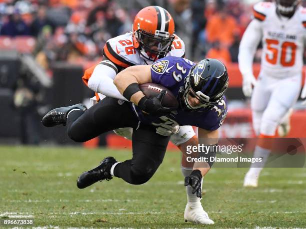 Running back Danny Woodhead of the Baltimore Ravens is tackled by safety Derrick Kindred of the Cleveland Browns in the third quarter of a game on...