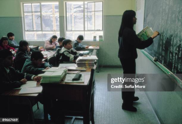 Rosary Hill school A pupil is writing on the blackboard during a class