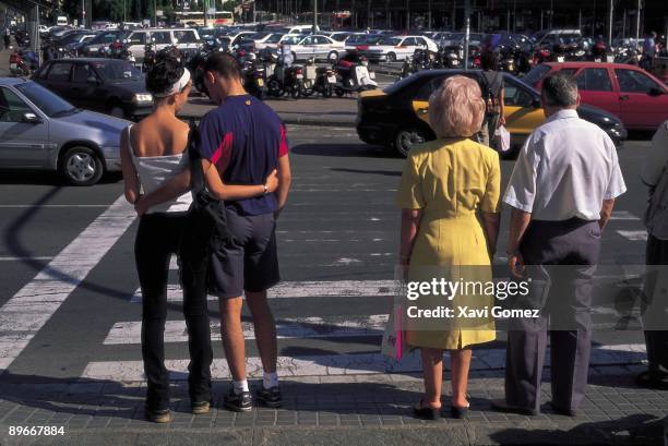 Couples Couples of different generations wainting to cross the street in a traffic light