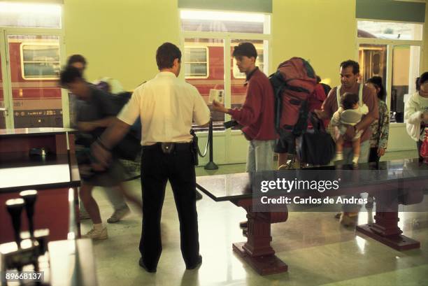 Youngs travellers Young men with ruck sacks at the customs in a the railway station of Port Bou