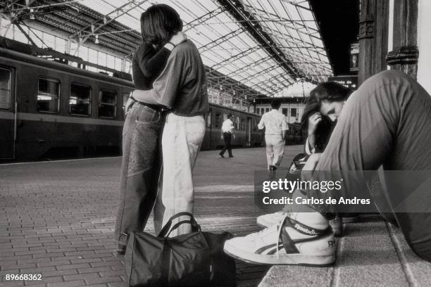 Couple kissing one another in a railway station View of couple kissing one another in the platform of a railway station