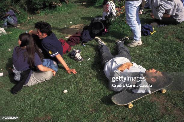 People in the FESTIMAD A group of youth resting and sleeping on the grass in music festival FESTIMAD