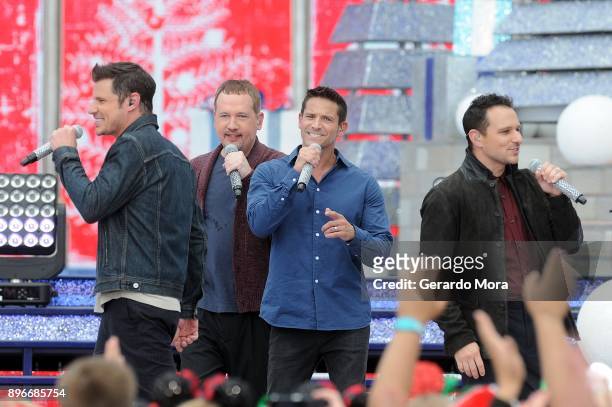 Nick Lachey, Justin Jeffre, Jeff Timmons and Drew Lachey of 98 Degrees perform during the taping of "Disney Parks Magical Christmas Celebration" at...