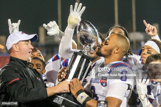 Louisiana Tech Bulldogs head coach Skip Holtz watches Louisiana Tech Bulldogs quarterback J'Mar Smith kiss the trophy after winning the Frisco Bowl...