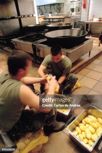 Marines peeling potatoes in the kitchen