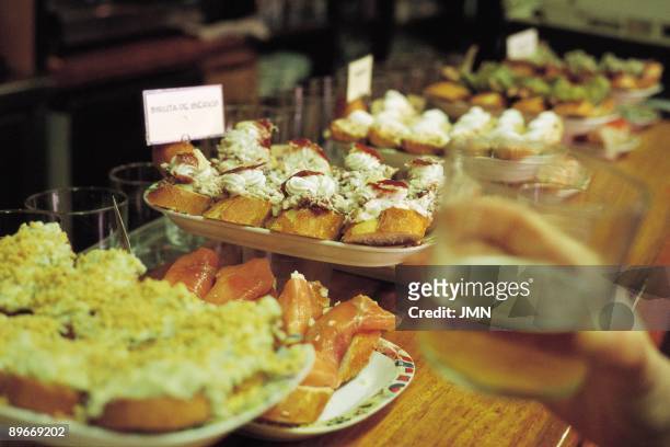 Pintxos. San Sebastian `In the Old Town of the city we can eat in the ``pintxos bars`` Pintxos are small portion of food.`