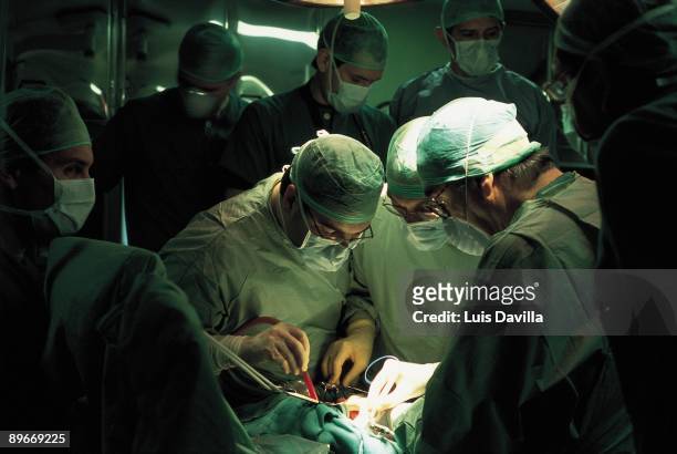 Intervencion quirurgica A group of surgeons operating a patient in a public hospital