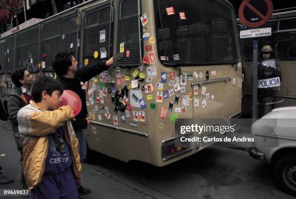 Demonstration against NATO A demonstrator put sticker against NATO in a van of the National Police