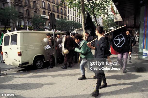 Manifestation against the American military bases. View of people with anarchist flags during the manifestation in Madrid against the American...