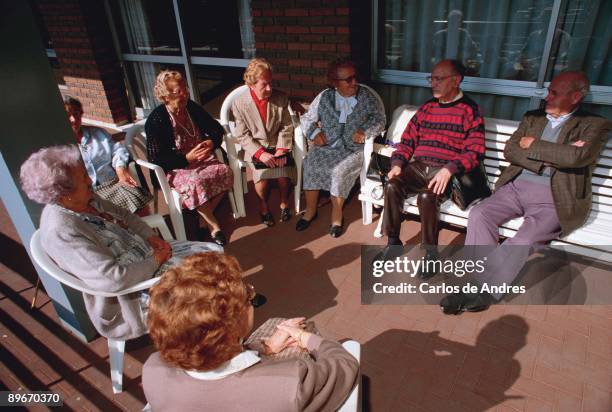 Bilbao, Spain. Group of pensioners chatting in his old age home.