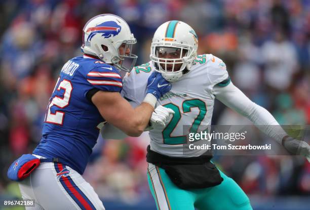 McDonald of the Miami Dolphins goes against Patrick DiMarco of the Buffalo Bills during NFL game action at New Era Field on December 17, 2017 in...