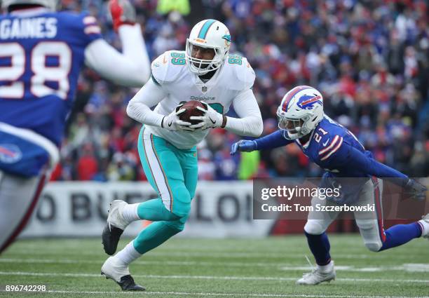 Julius Thomas of the Miami Dolphins runs with the ball during NFL game action against the Buffalo Bills at New Era Field on December 17, 2017 in...