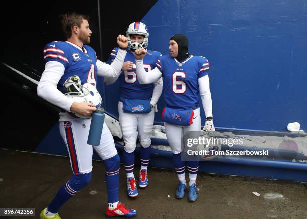 Stephen Hauschka of the Buffalo Bills greets Colton Schmidt and Reid Ferguson in the tunnel before the start of their NFL game against the Miami...