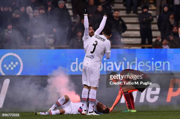 Alberto Gerbo of Foggia lies on the pitch after hitting by a flare, as he was celebrated his team's second goal during the Serie B match between US...
