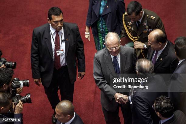 Pedro Pablo Kuczynski, Peru's president, center, shakes hands with an attendee after testifying before the National Congress in Lima, Peru, on...
