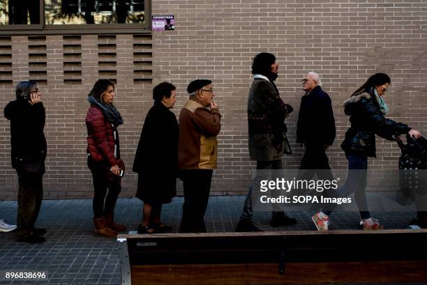 Residents seen queuing up heading to the polling station for the Catalonia regional election. Catalan started today to elect a new regional...