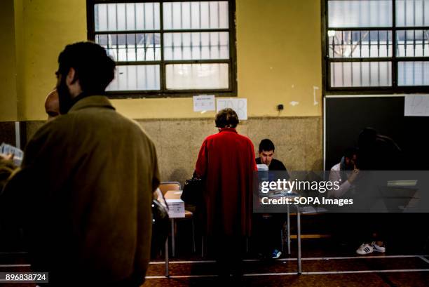 Woman seen casting her vote at a polling station for the Catalonia regional election. Catalan started today to elect a new regional government, with...
