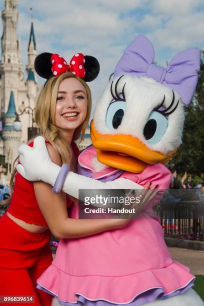 In this handout photo provided by Disney Parks, Disney Channel's "Bunk'd" actress Peyton List poses with Daisy Duck at Magic Kingdom Park on December...