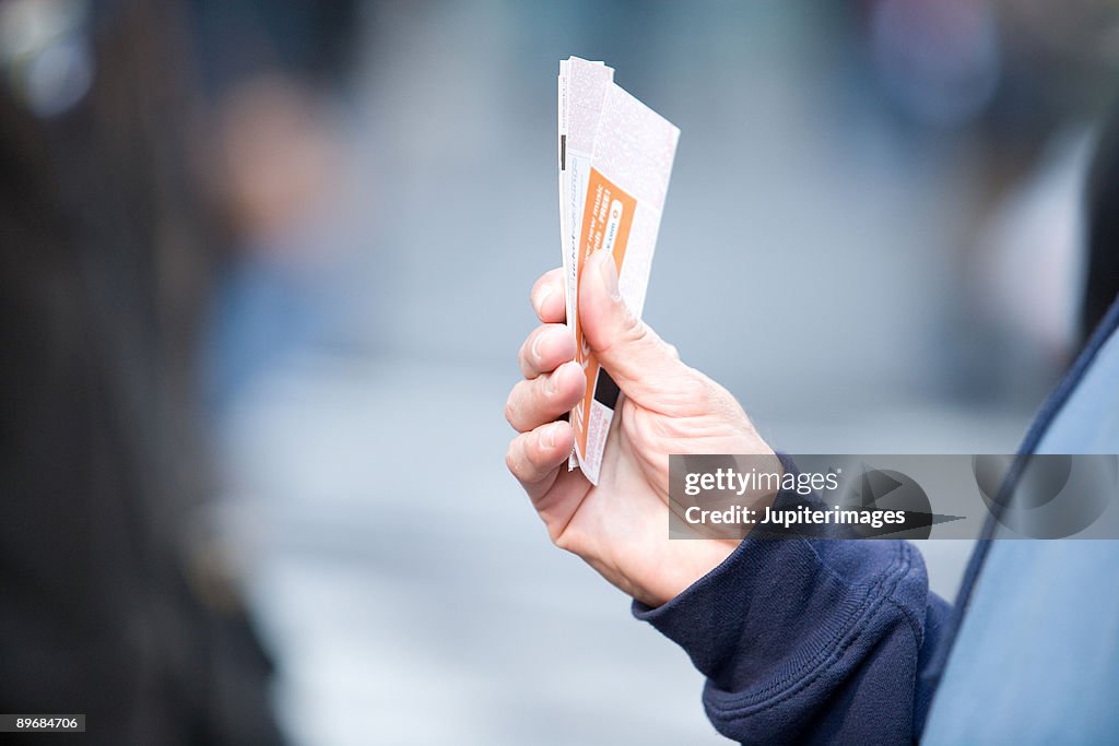 Hand holding tickets