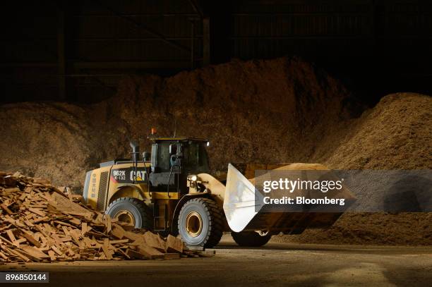Front loader moves sawdust in a yard at the Gonoike Biomass Power Station, operated by Gonoike Bioenergy Corp., a subsidiary of Mitsubishi Corp., in...