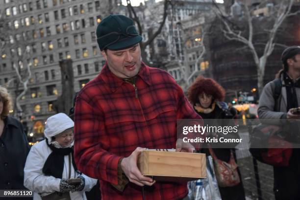 Participants participate in an ephemeral thumb-piano parade through Madison Square Park during the "Kalimbascope" event as part of "Make Music...