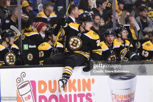 Colby Cave of the Boston Bruins hops off the bench in his first NHL game against the Winnipeg Jets at the TD Garden on December 21, 2017 in Boston,...
