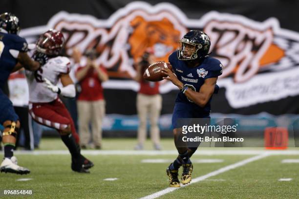 Quarterback Maurice Alexander of the Fiu Golden Panthers looks for an open receiver during the second quarter of the Bad Boy Mowers Gasparilla Bowl...