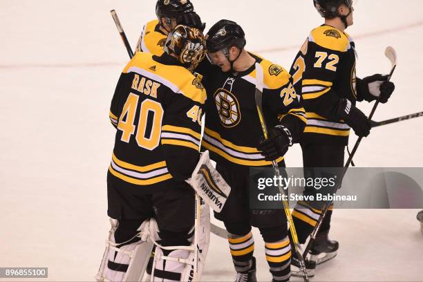 Tuukka Rask and Colby Cave of the Boston Bruins celebrate a shootout win against the Winnipeg Jets at the TD Garden on December 21, 2017 in Boston,...