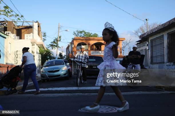 Girl marches during a student Christmas parade on December 21, 2017 in Loiza, Puerto Rico. The parade mixed traditional Catholic and Afro-Puerto...