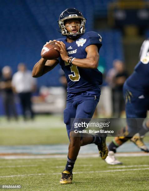 Quarterback Maurice Alexander of the Fiu Golden Panthers looks for a receiver during the third quarter of the Bad Boy Mowers Gasparilla Bowl against...