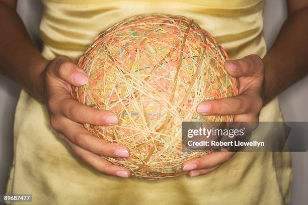 person holding large rubber band ball - elastic band ball stock pictures, royalty-free photos & images