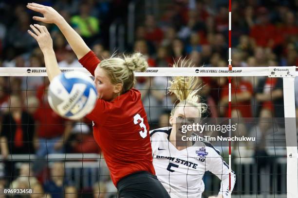 Ali Frantti of Penn State University pikes the ball past Kelly Hunter of the University of Nebraska during the Division I Women's Volleyball...