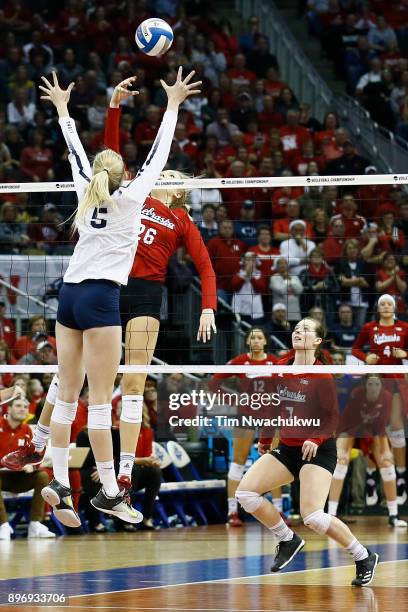 Lauren Stivrins of the University of Nebraska taps the ball past Ali Frantti of Penn State University during the Division I Women's Volleyball...