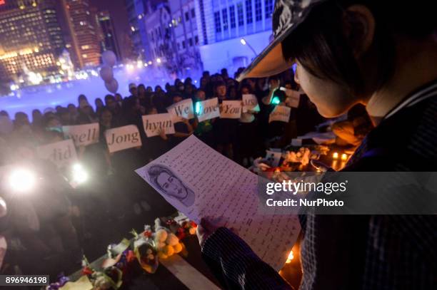 Malaysian K-pop fans reads a letter as they gather for vigil after the death of Kim Jong-Hyun, a 27-year-old lead singer of the massively popular...
