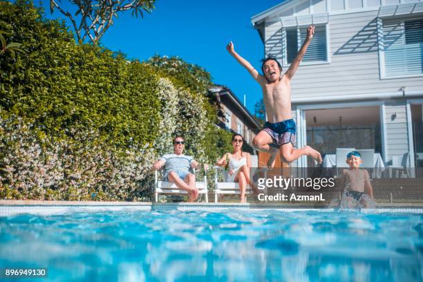 swimming and having fun - swimming pool stock pictures, royalty-free photos & images