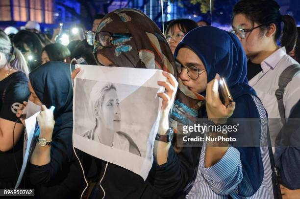 Malaysian Muslim K-pop fans react as they gather for vigil after the death of Kim Jong-Hyun, a 27-year-old lead singer of the massively popular K-pop...
