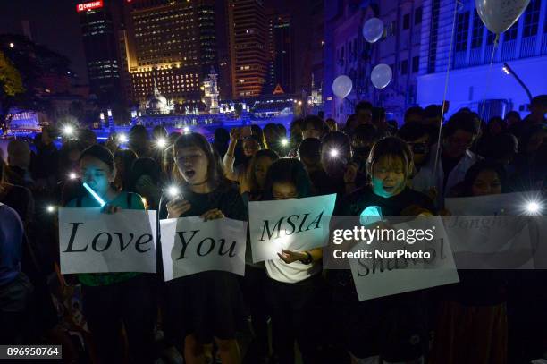 Malaysian K-pop fans react as they gather for vigil after the death of Kim Jong-Hyun, a 27-year-old lead singer of the massively popular K-pop...