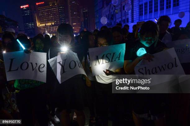 Malaysian K-pop fans react as they gather for vigil after the death of Kim Jong-Hyun, a 27-year-old lead singer of the massively popular K-pop...