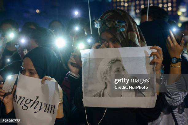 Malaysian Muslim K-pop fans react as they gather for vigil after the death of Kim Jong-Hyun, a 27-year-old lead singer of the massively popular K-pop...