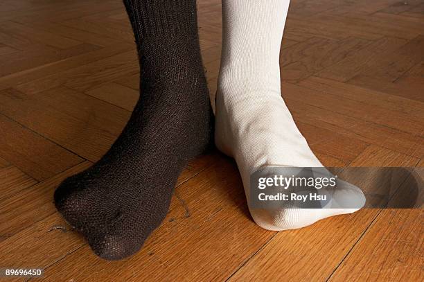 person in mismatched socks - mismatch stock-fotos und bilder