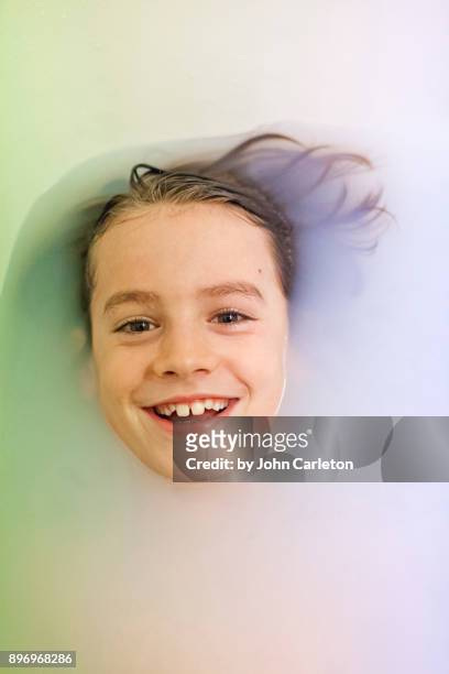 happy boy floating in bath water - bainbridge island wa stock pictures, royalty-free photos & images