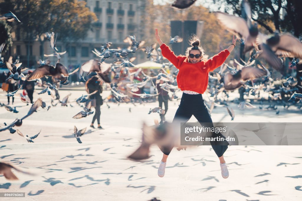 Girl jumping from joy in Barcelona