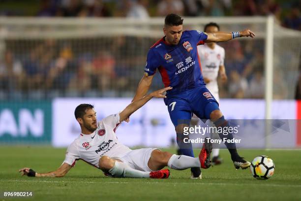 Dimitri Petratos of the Jets contests the ball with Brendan Hamill of the Wanderers during the round 12 A-League match between the Newcastle Jets and...