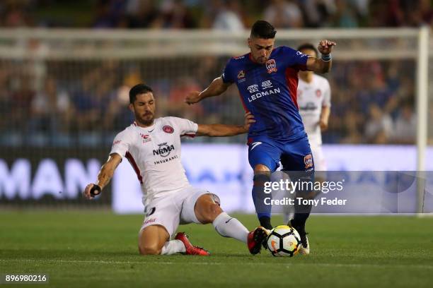 Dimitri Petratos of the Jets contests the ball with Brendan Hamill of the Wanderers during the round 12 A-League match between the Newcastle Jets and...