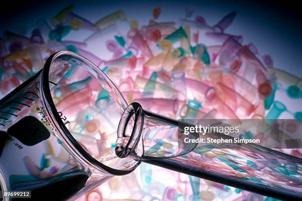 test tube pouring into beaker - liquid solution stock pictures, royalty-free photos & images