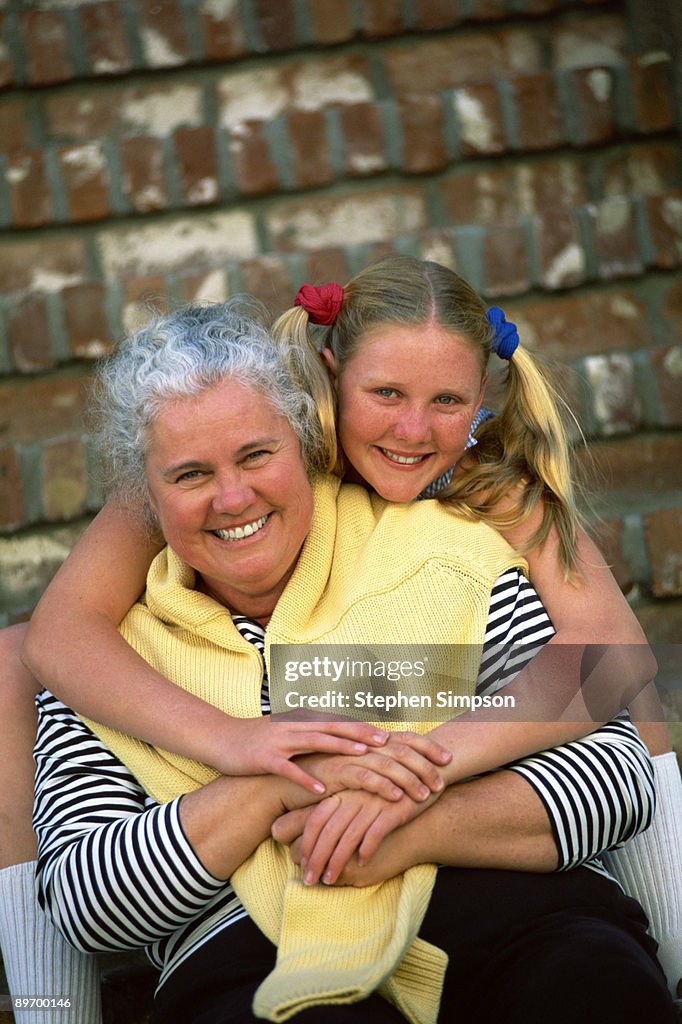 Portrait of mother and daughter embracing